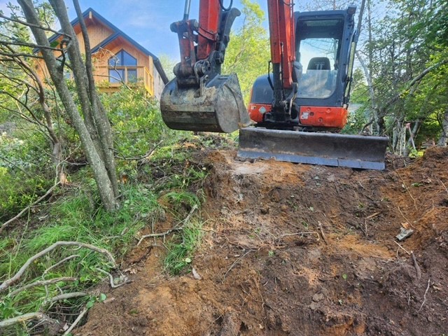 landscaping and hardscaping with backhoe